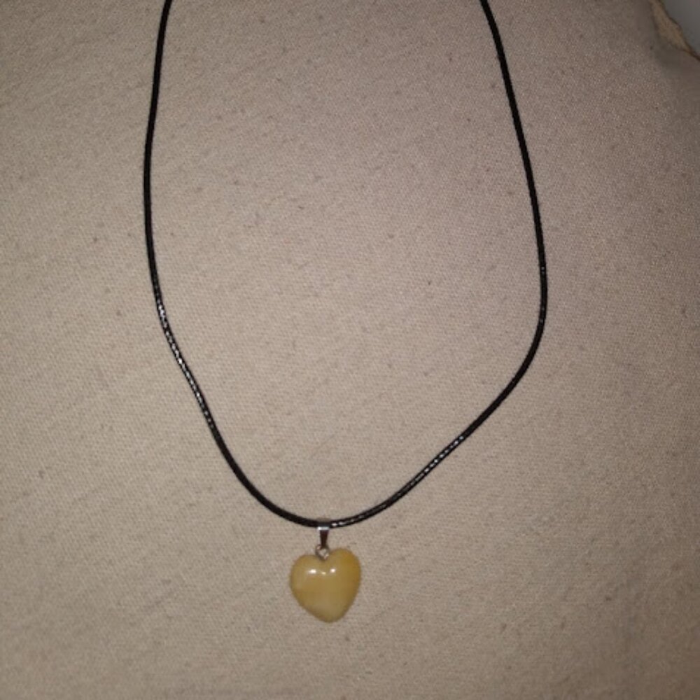 Beige heart shaped stone pendant necklace.